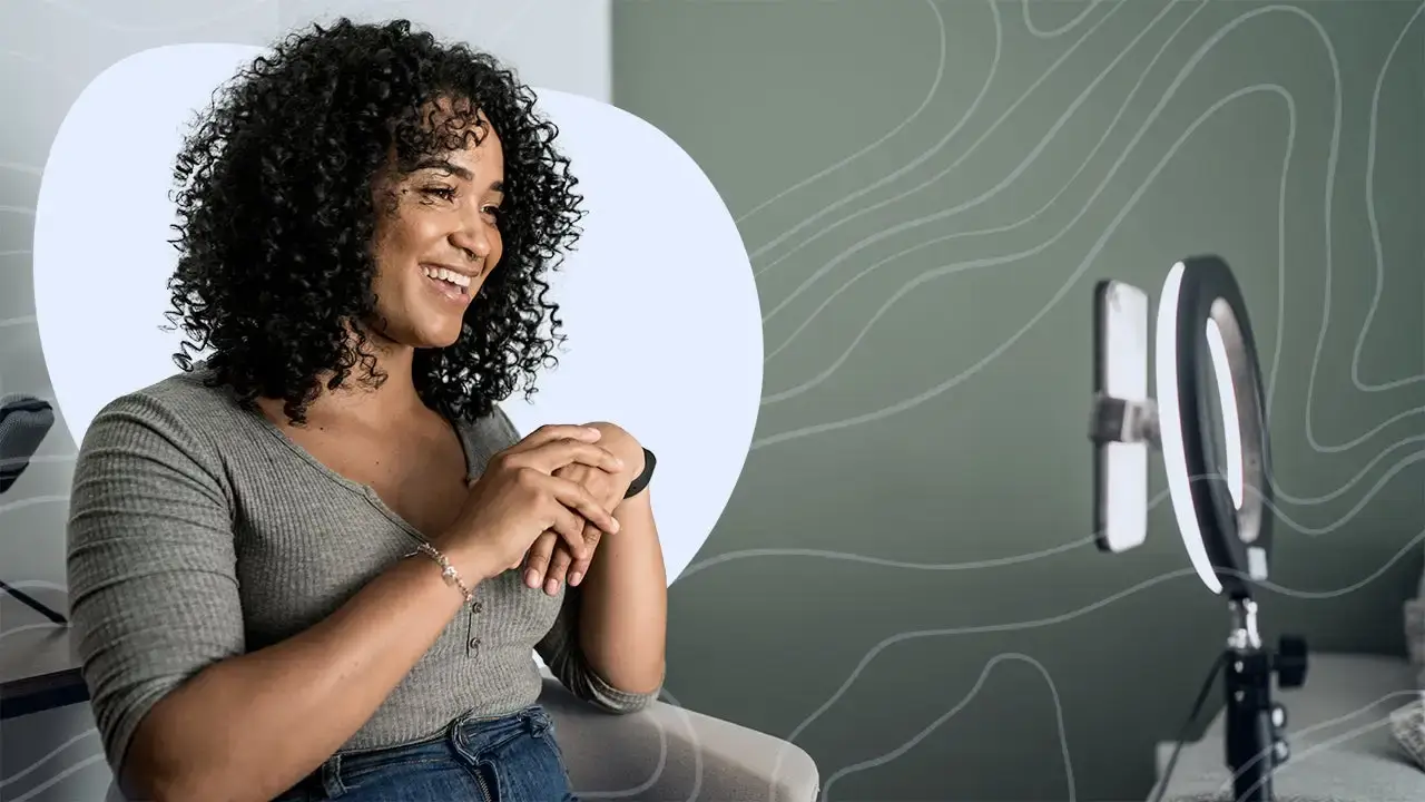 A person filmed with poor, grainy indoor lighting.