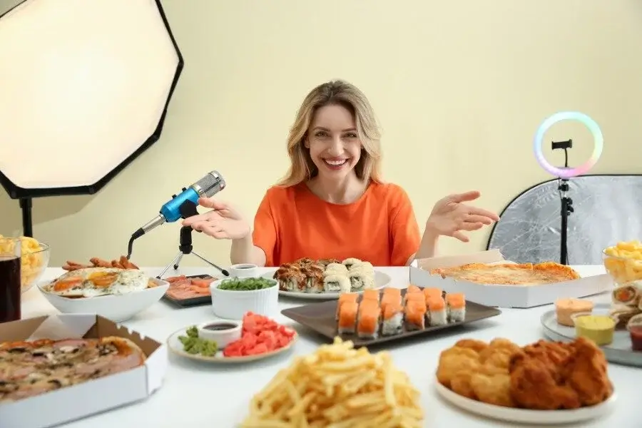A chef using an LED panel to beautifully light a dish for a food blog.