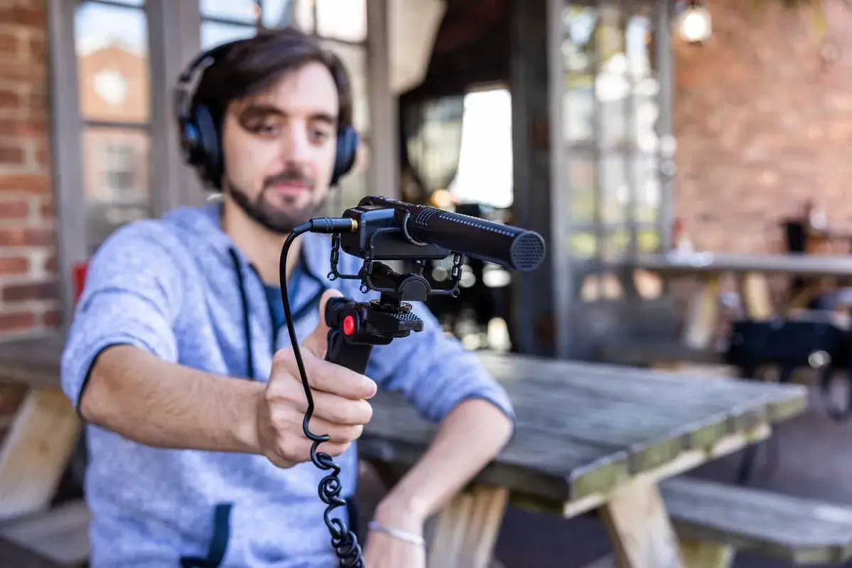 A travel vlogger capturing audio on the go with an on-camera shotgun microphone.