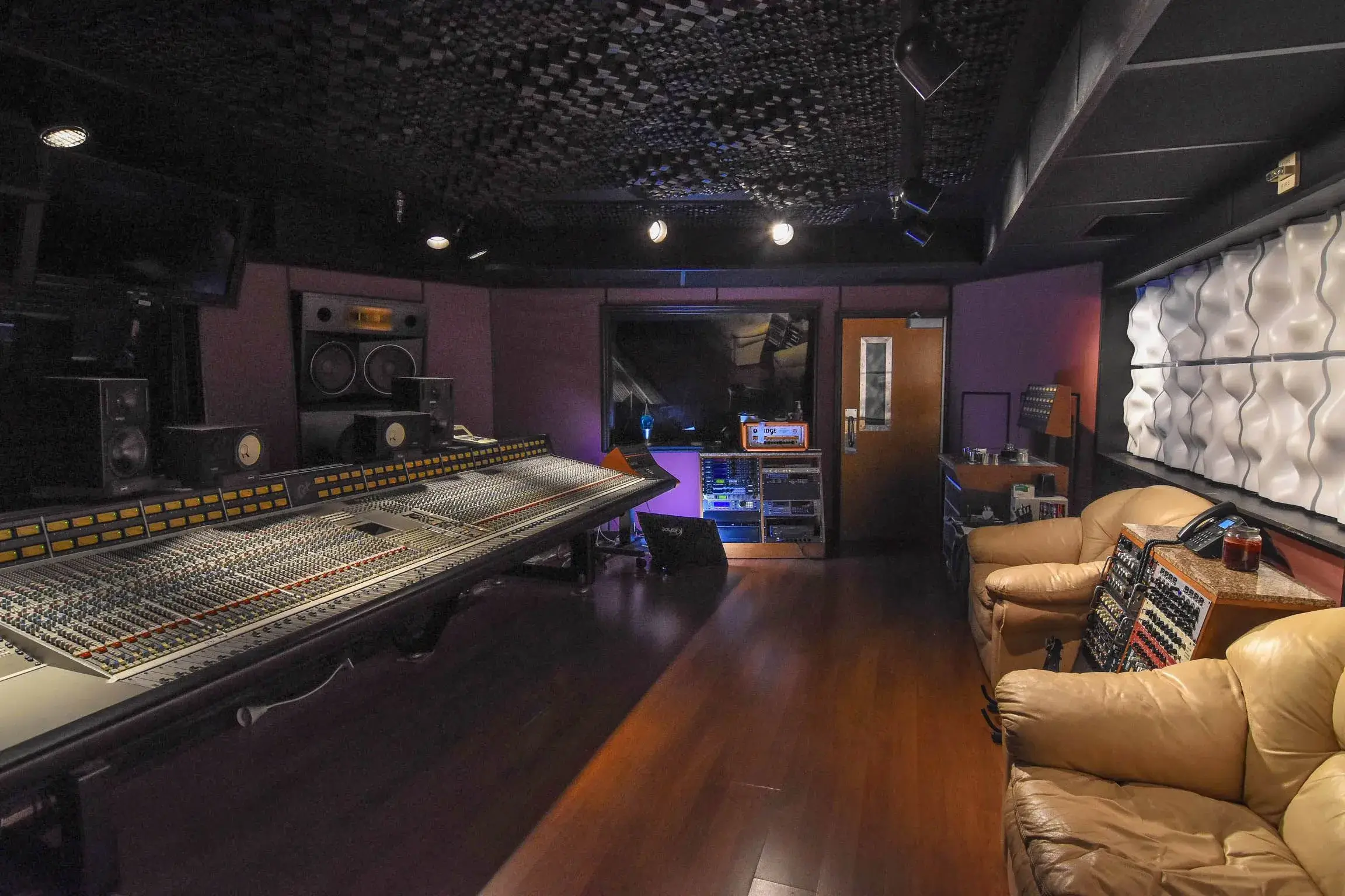 A home studio with blankets and pillows used for sound absorption.